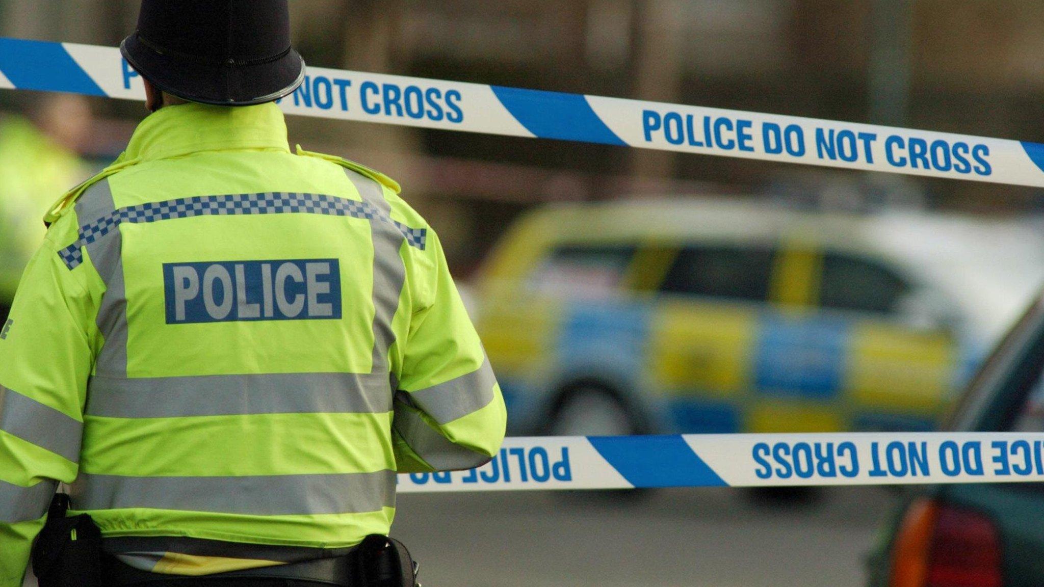 Policeman in front of a cordon