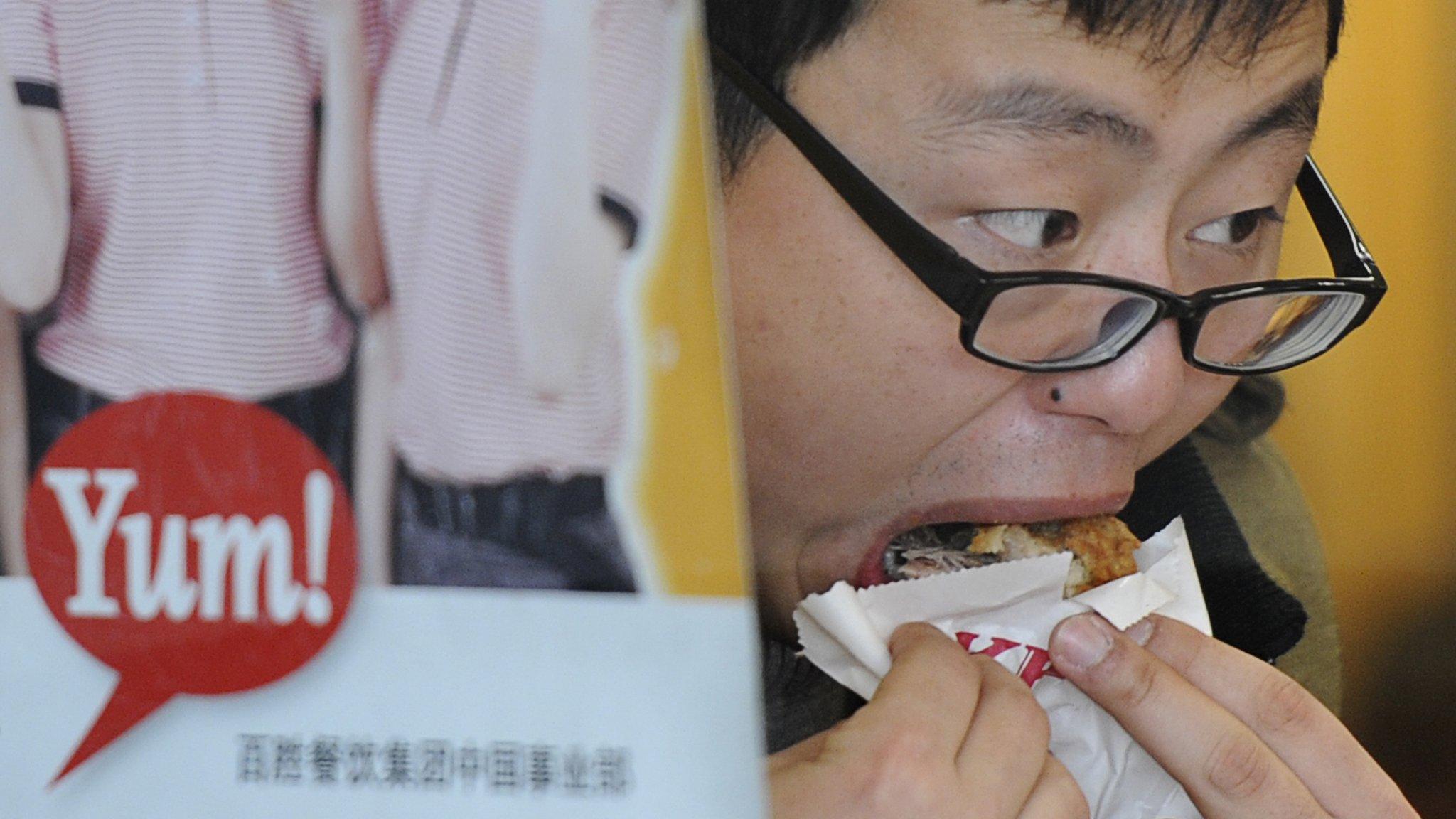 A man eating at KFC in China