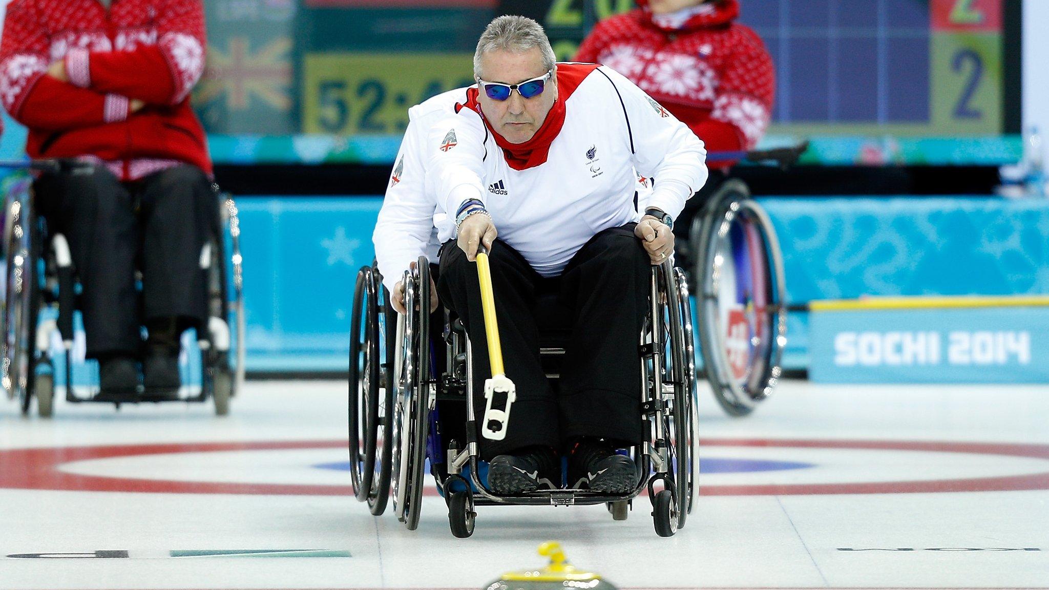 Jim Gault delivers a stone at the Sochi Paralympics