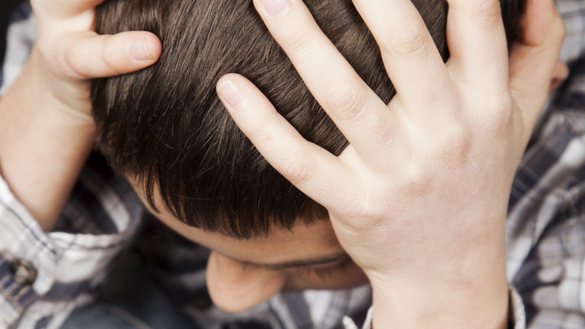 A child with his head in his hands