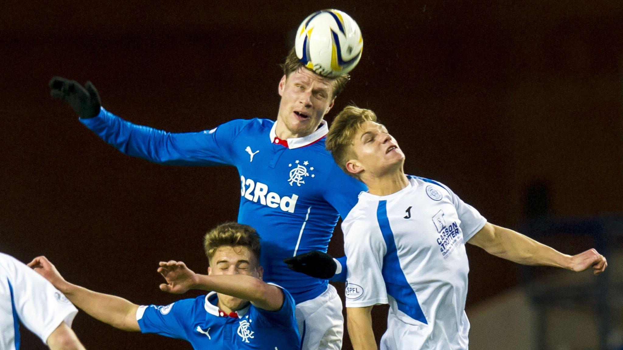 Marius Zaliukas and Gavin Reilly challenge for the ball