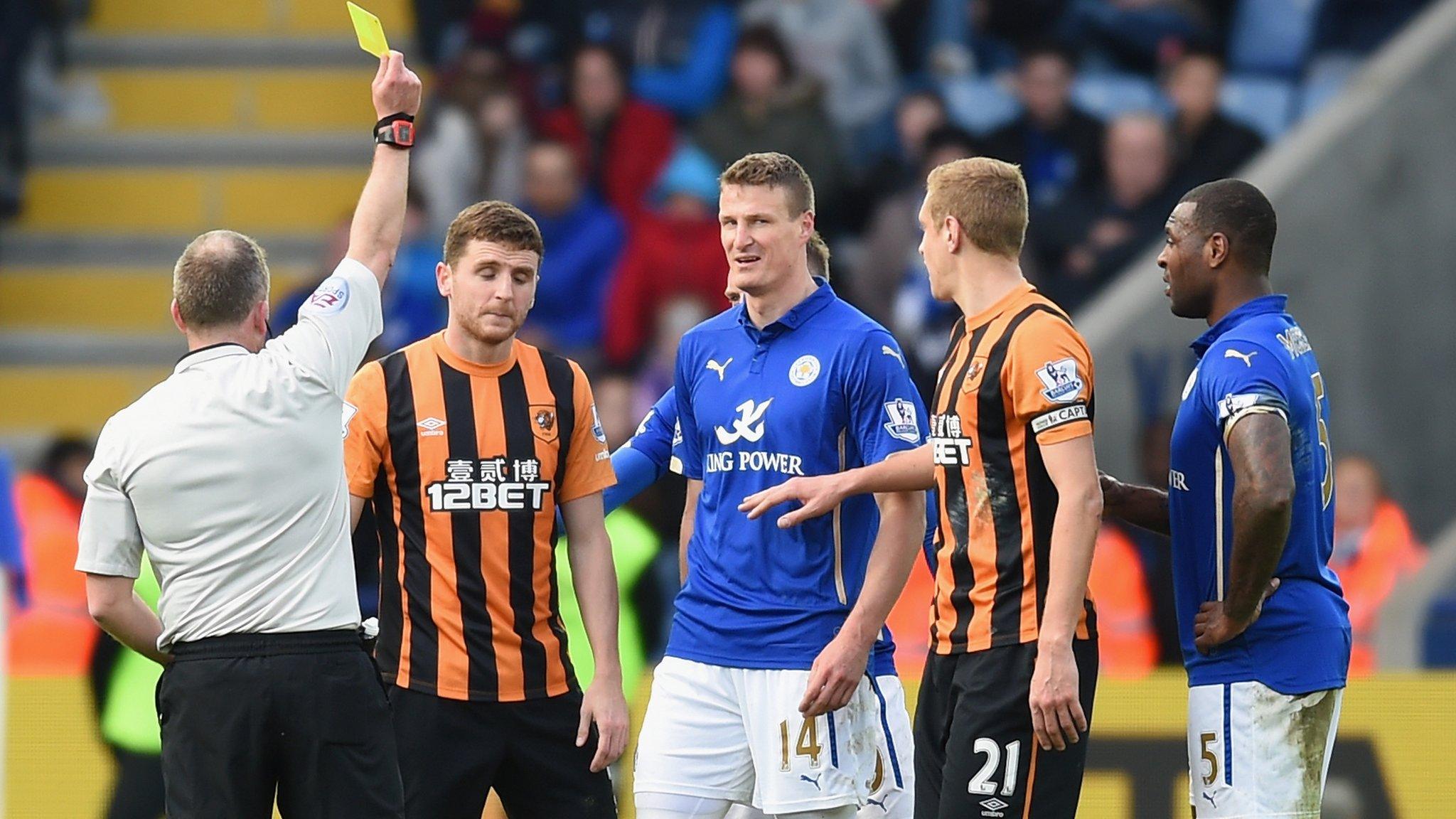 Alex Bruce is shown a yellow card at Leicester