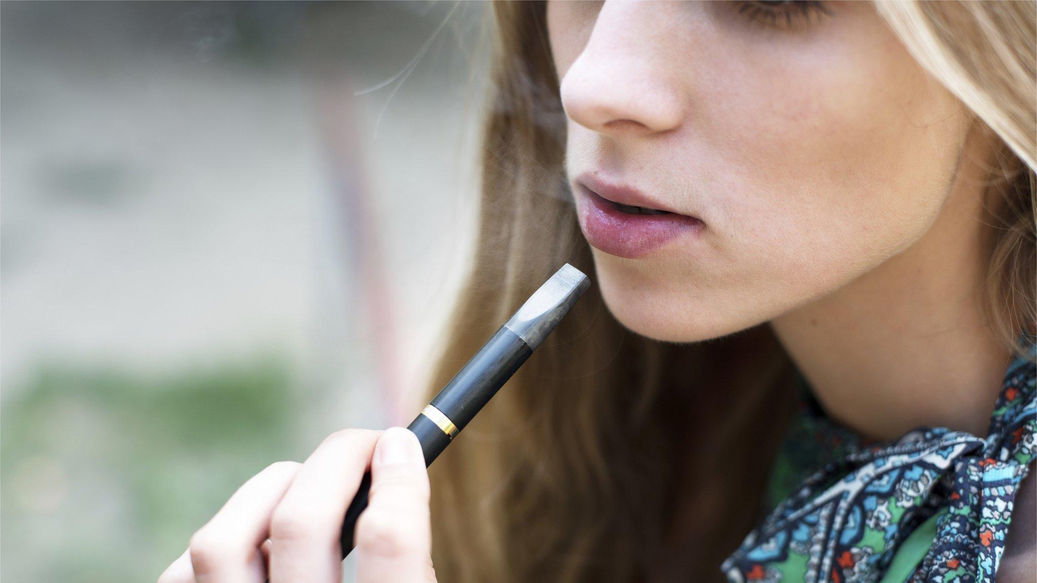 Teenager smoking e-cigarette