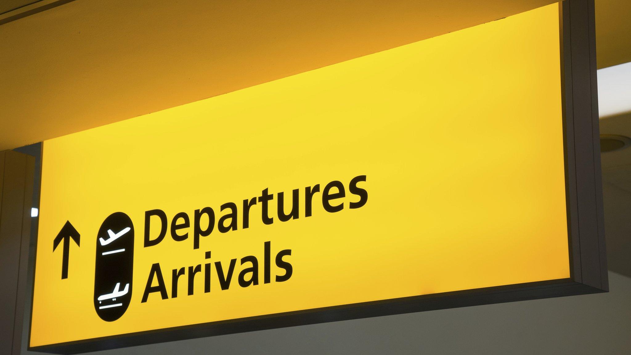 Airport sign pointing to arrivals annd departures