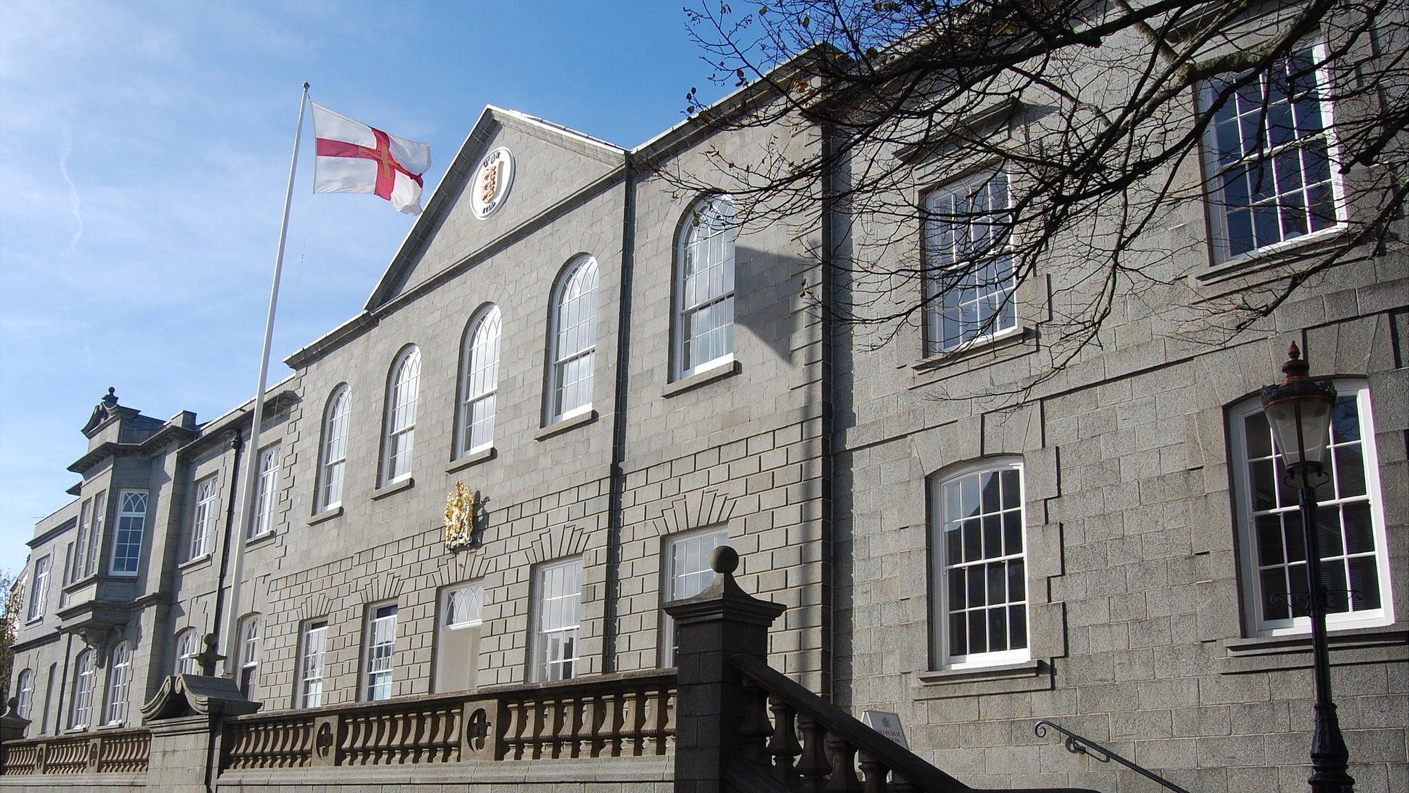 Guernsey flag flying outside the Royal Court building