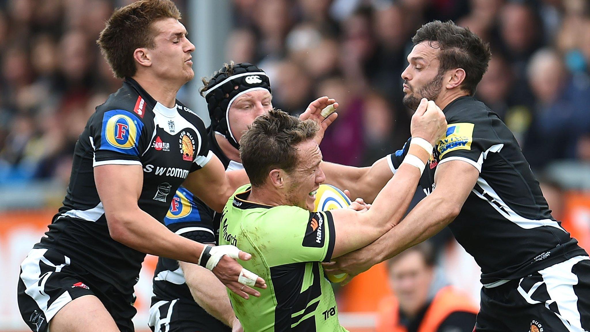 James Wilson of Northampton is tackled by Exeter's Henry Slade (left) among others