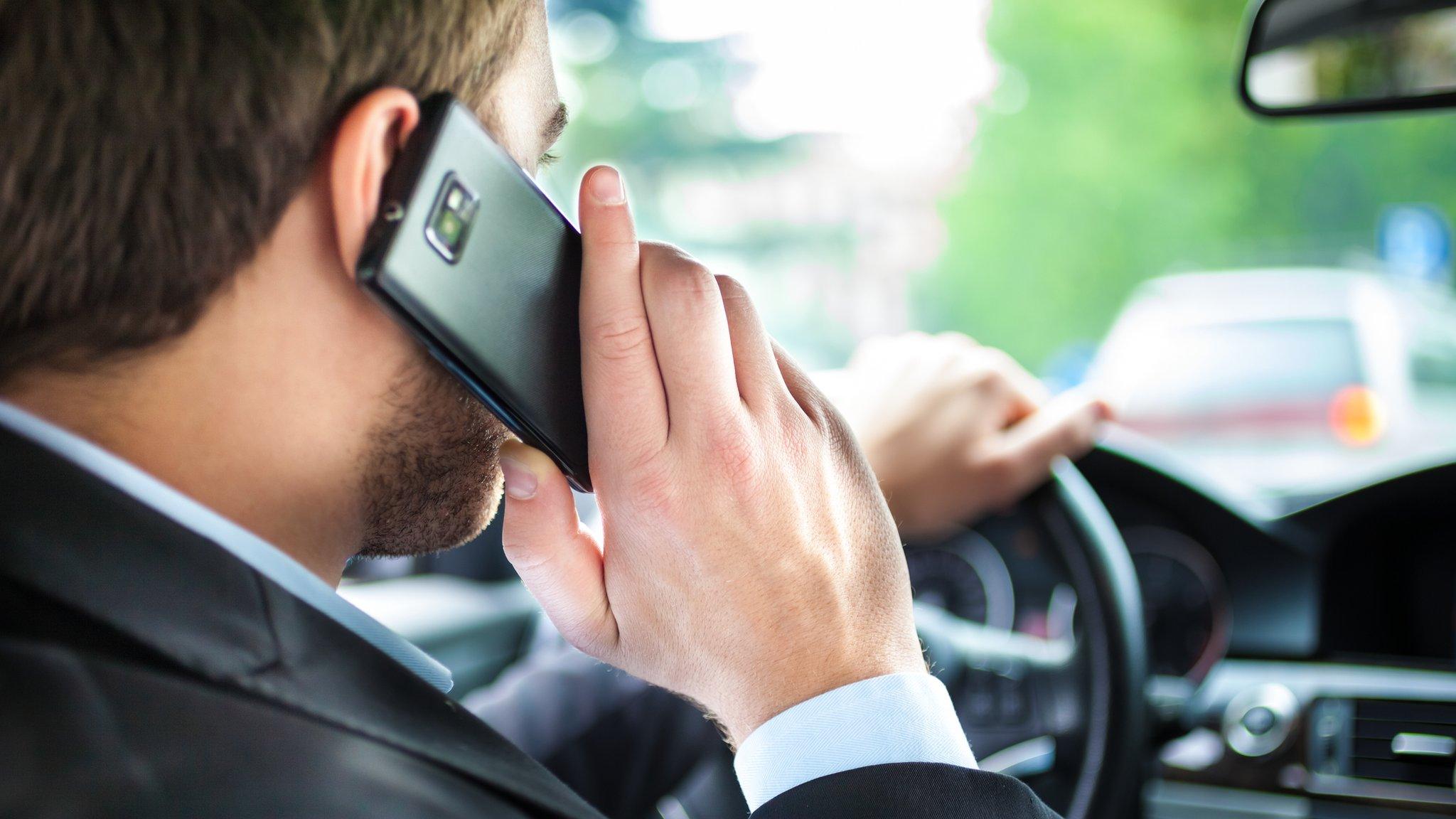 Man driving with using mobile phone