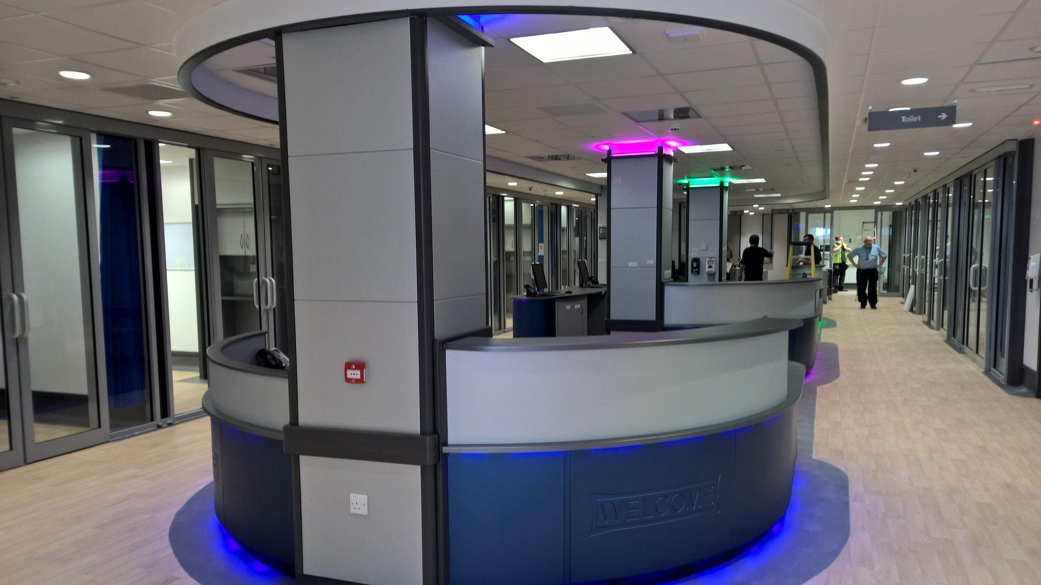 Man in the distance walking alongside a state of the art reception desk