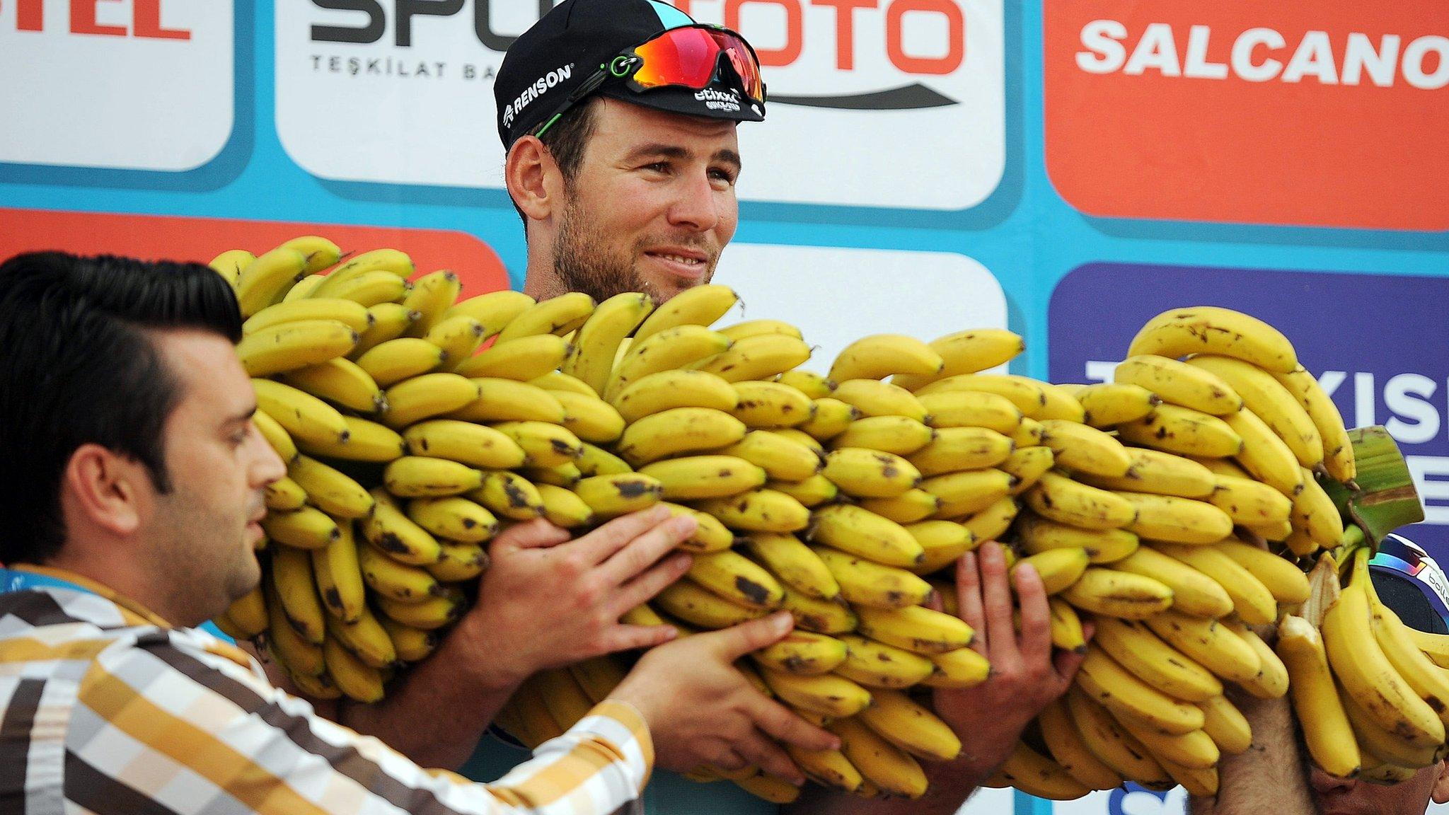 Mark Cavendish is presented with a large bunch of bananas