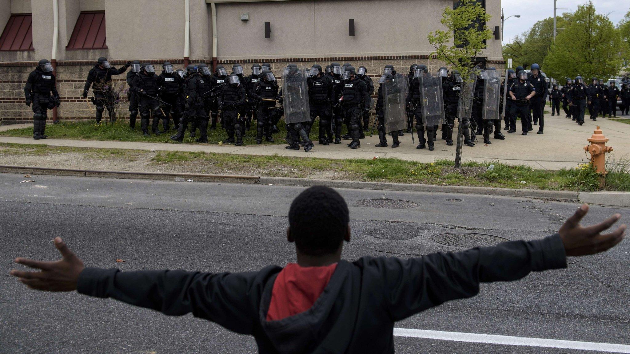 A protestor gestures to police