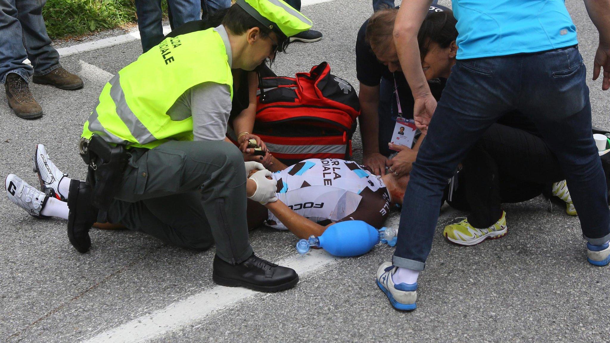 Italian rider Domenico Pozzovivo receives medical treatment after his fall during the third stage of the 98th Giro d"Italia