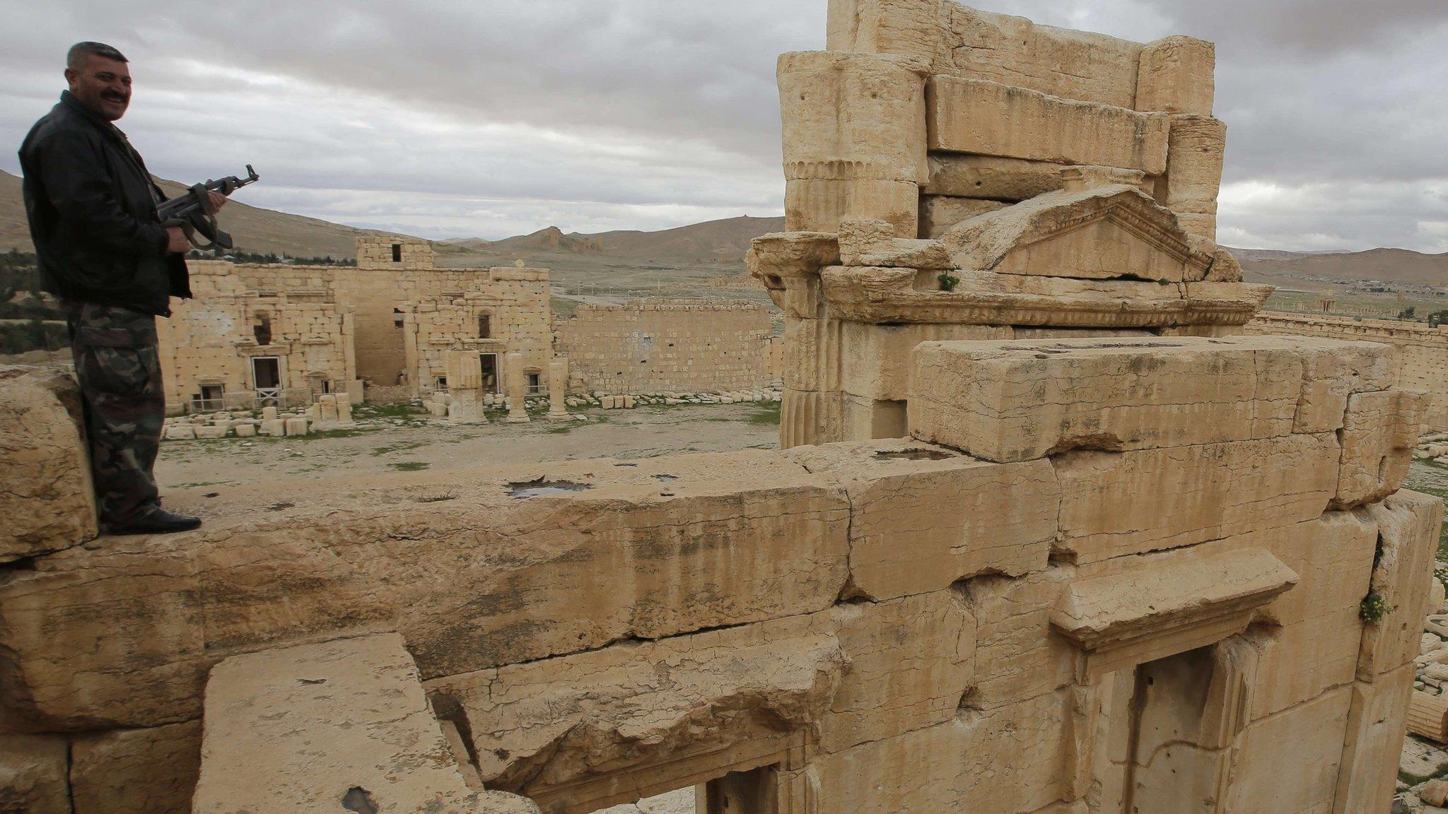 Syrian policeman stands on a wall of the great temple of Baal, at Palmyra (14 March 2014)