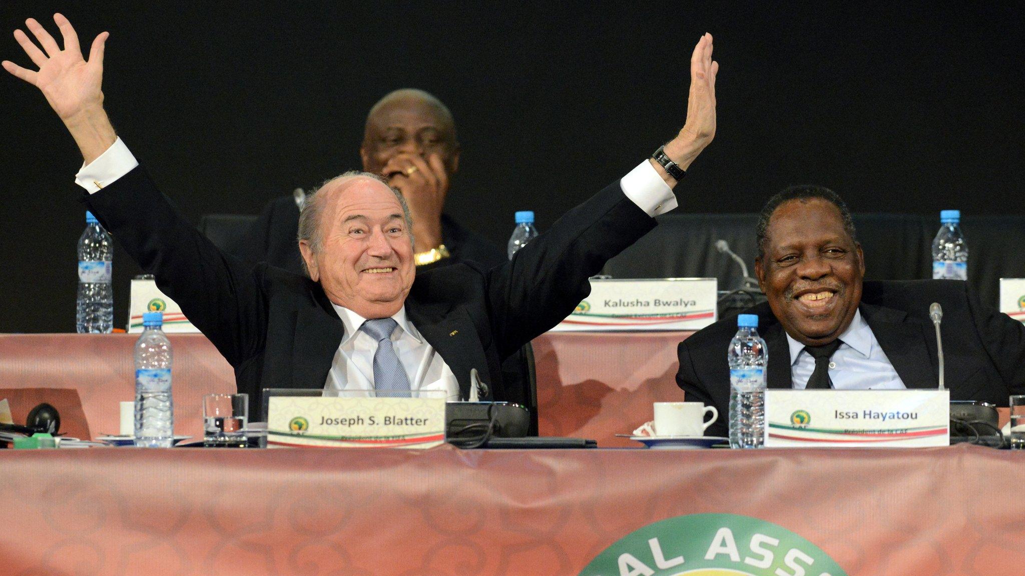 FIFA's president Sepp Blatter (L) gestures as he shares a joke with the public during a general assembly meeting after Cameroonian Issa Hayatou (R) was re-elected unopposed as president of the Confederation of African Football (CAF) on March 10, 2013, in Marrakesh.