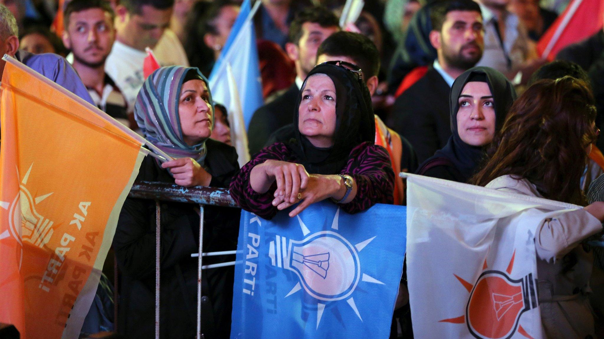 Supporters listen to Turkey's Prime Minister and leader of the ruling Justice and Development Party Ahmet Davutoglu as he speaks from the balcony of his party in Ankara, Turkey, late Sunday, June 7, 2015.