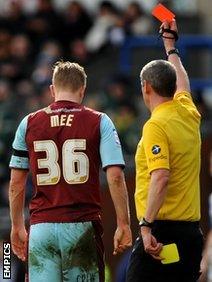 Ben Mee is shown a red card by referee Andy D'Urso