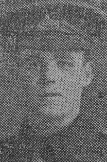 A grainy photograph showing a soldier in WW1 uniform, including a peaed cap.
