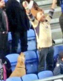 A Leeds fan celebrates his side's win over Wigan with his dog