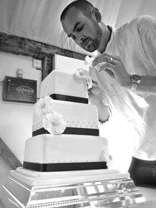 Chris putting the final touches to a multi-tiered cake