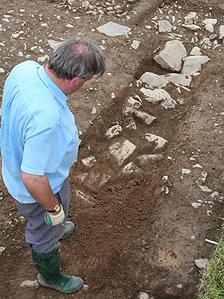 Archaeologist at the excavated walls