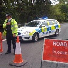 Police officer guarding a road