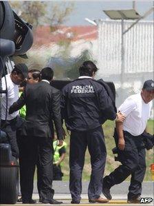 Journalists Javier Canales Fernandez (L) of Multimedios Torreon and Alejandro Hernandez Pacheco (R) of Televisa are escorted out of an helicopter on 31 July after being rescued