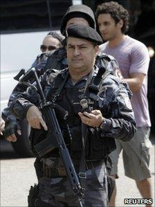 Police stand guard as tourists are evacuated from the hotel