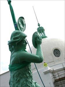 Close-up of one of the statues with the dome behind