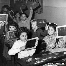 Children hold up slates