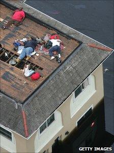 People await help on their rooftop during flooding caused by Hurricane Katrina