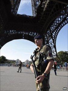 A French soldier patrols around the Eiffel Tower, Paris, 20 September