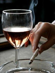 A smoker with a drink in a pub