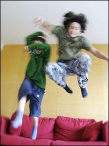 Children jumping on sofa