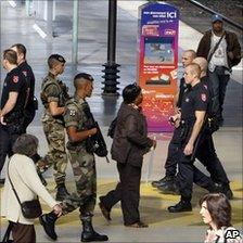 French soldiers patrol a train station