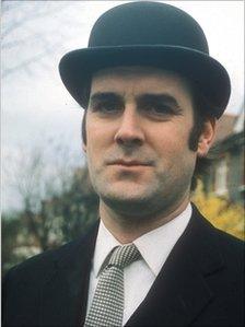 John Cleese in the bowler hat and suit