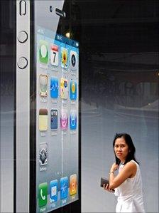 Woman walks past an iPhone advert