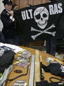 Police displaying weapons found after they arrested three Napoli fans