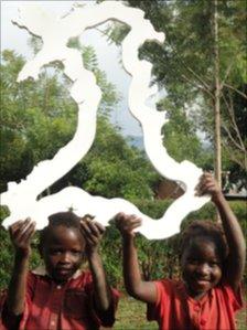 Uganda children holding a map of Wales