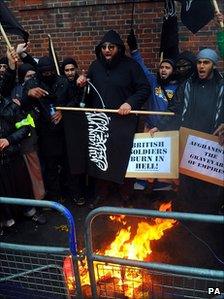 Muslims protesters burn a poppy at a Muslims against Remembrance Day protest on Exhibition Road in London