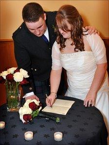 Married couple sign the register. Photo: Chris Wright Photography