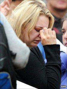 A woman weeps amid family and friends of the 29 coal miners who are trapped underground after an explosion near Greymouth in New Zealand, 21 November 21 2010