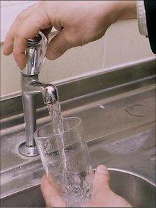 Glass being filled with water from the tap