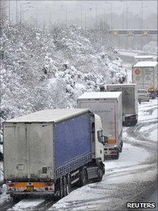 Lorries parked on the hard shoulder of the M25 motorway near Reigate