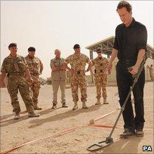 David Cameron uses a metal detector