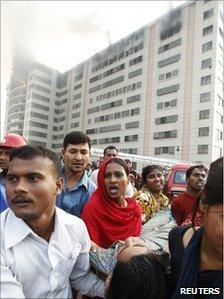Workers and injured colleague at a clothes factory in Ashulia, Dhaka, 14/12