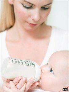 Mother bottle feeding a baby