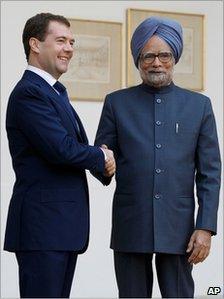 Russian President Dmitry Medvedev, left, poses for photographs with Indian Prime Minister Manmohan Singh in New Delhi, India, Dec. 21, 2010.