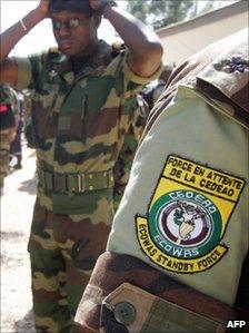An officer from the West African standby force his cap during exercises during military manoeuvres in Senegal