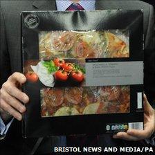 Detective holding a Tesco Finest tomato, mozzarella and basil pesto pizza