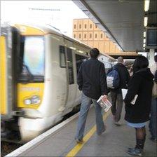 Commuters about to board a train at London Bridge Station, London