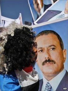 A supporter of President Saleh kisses his portrait in Sanaa, 3 February